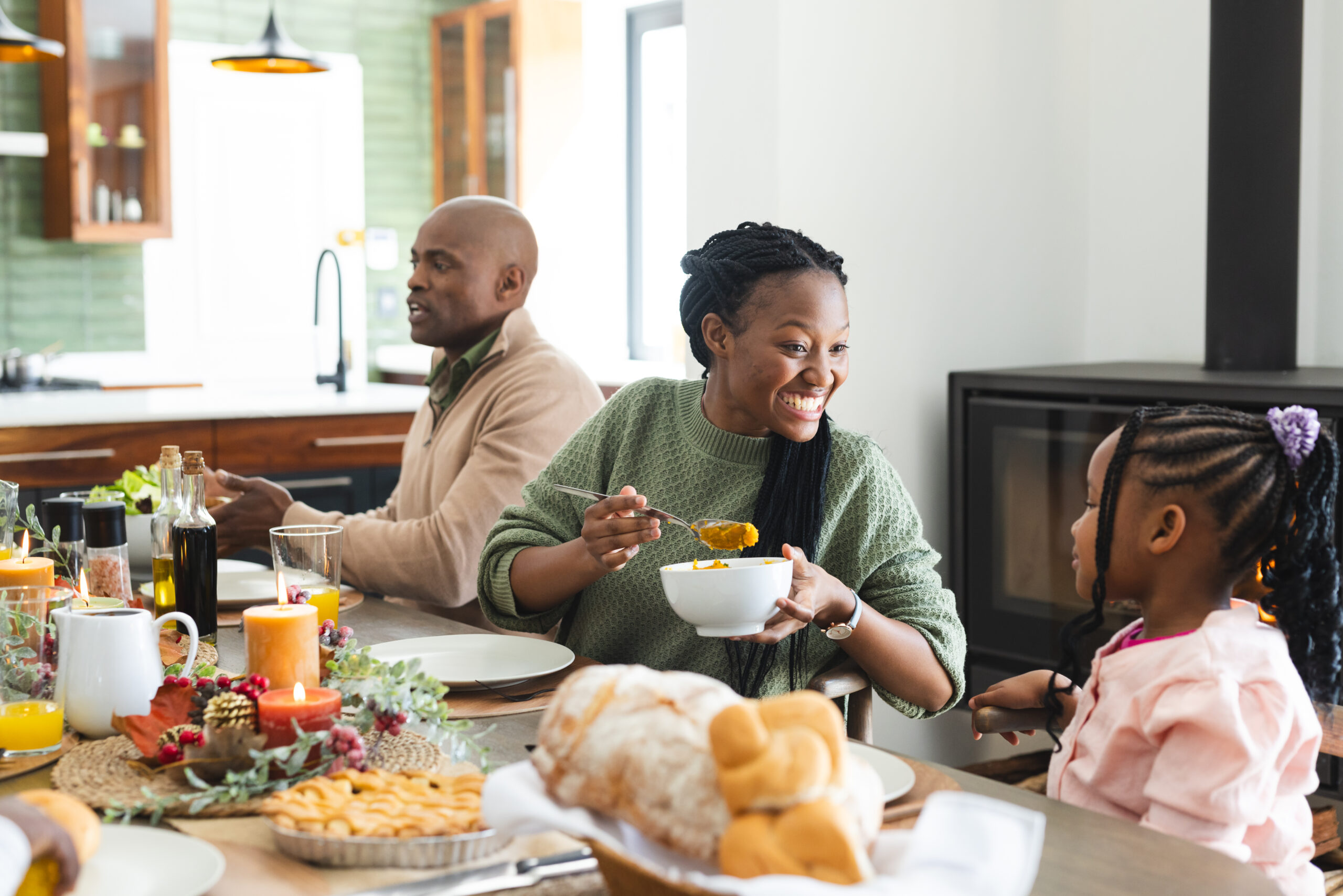 Happy african american mother serving food for daughter at thanksgiving dinner. Thanksgiving, celebration, meal, home, family, togetherness,